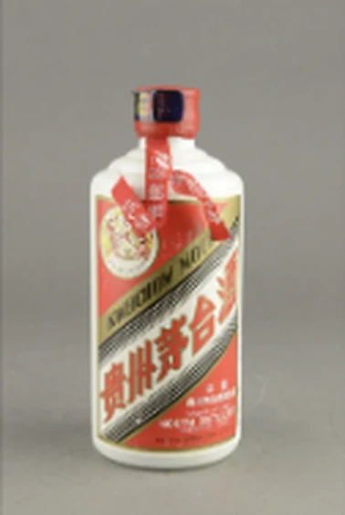 A white ceramic baijiu bottle with red cap, red ribbons and a red and gold label.